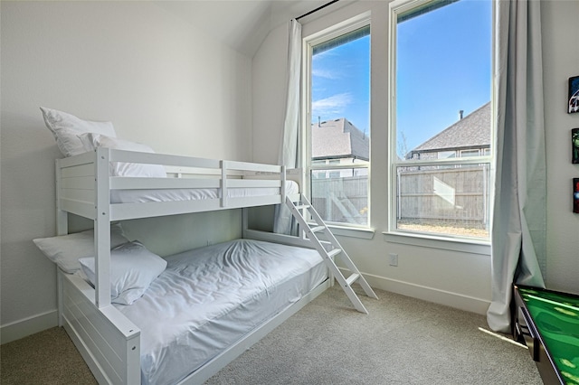 bedroom featuring baseboards and carpet