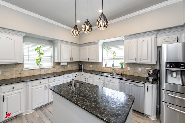 1231 Whitehall Dr, Bossier City, LA 71112 - kitchen with a sink, appliances with stainless steel finishes, crown molding, and white cabinetry