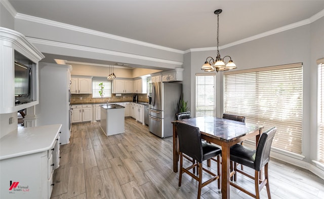 1231 Whitehall Dr, Bossier City, LA 71112 - dining room with ornamental molding, light wood finished floors, and an inviting chandelier