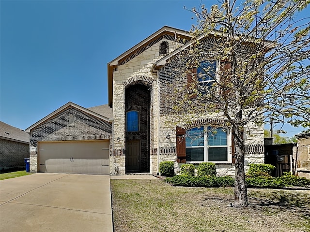 french country inspired facade with brick siding, driveway, stone siding, and a garage