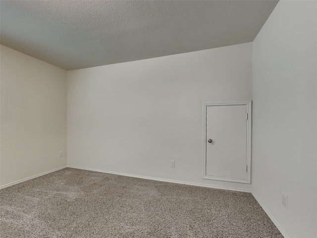 unfurnished room with carpet flooring and baseboards