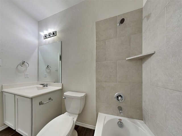 full bathroom with toilet, vanity, wood finished floors, and  shower combination