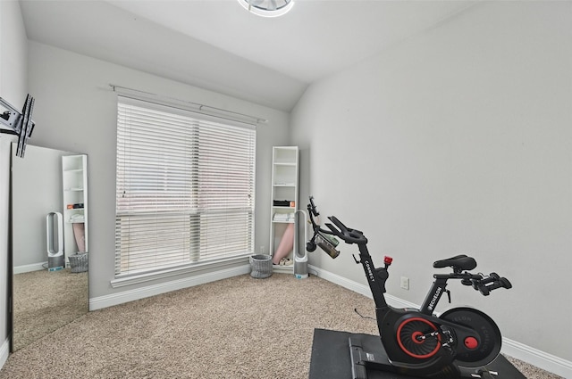 exercise area with carpet flooring, baseboards, and lofted ceiling