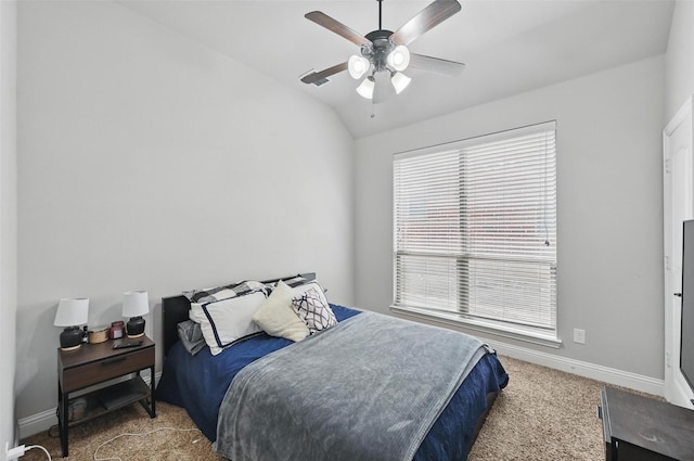 carpeted bedroom featuring baseboards, vaulted ceiling, and a ceiling fan