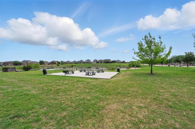 view of home's community with a yard and a patio area