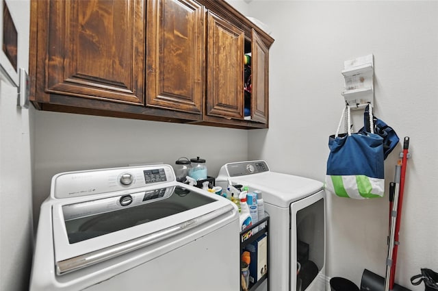 laundry area featuring cabinet space and washing machine and clothes dryer