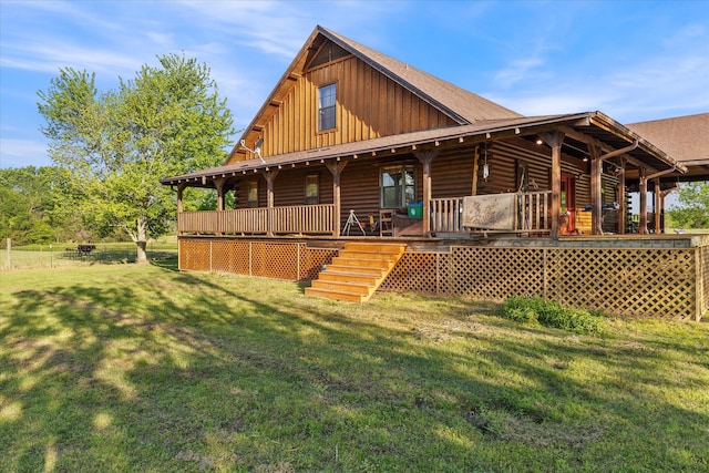 rear view of house with a yard, board and batten siding, and covered porch
