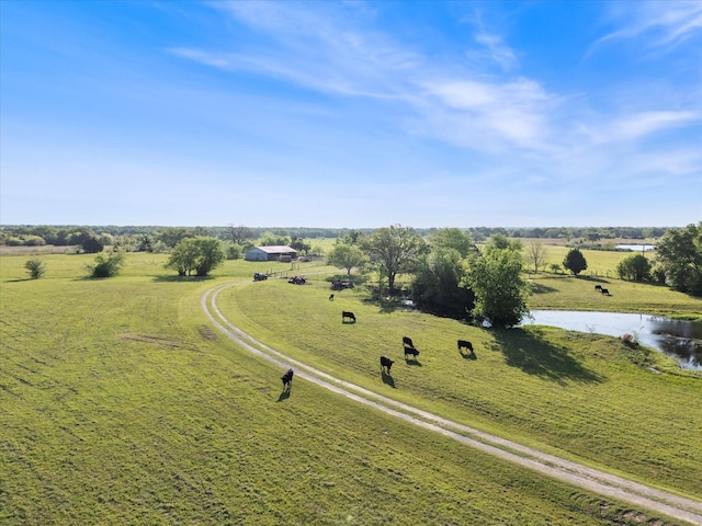 birds eye view of property with a rural view and a water view
