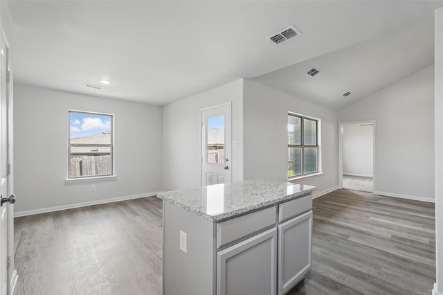 14203 Riata Ln, Dallas, TX 75253 - kitchen featuring open floor plan, visible vents, a center island, and wood finished floors