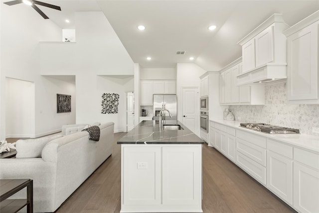 1013 Canuela Way, Fort Worth, TX 76247 - kitchen with appliances with stainless steel finishes, a sink, open floor plan, dark countertops, and high vaulted ceiling