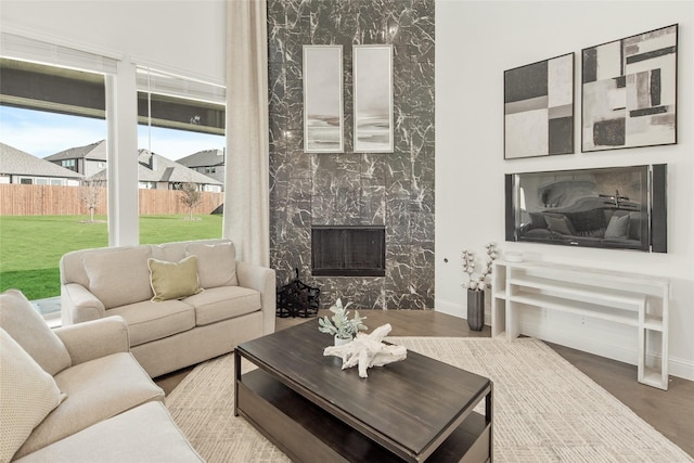 1013 Canuela Way, Fort Worth, TX 76247 - living area featuring light wood-type flooring, healthy amount of natural light, a premium fireplace, a high ceiling, and recessed lighting