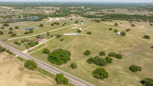 birds eye view of property featuring a water view and a rural view