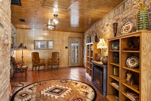 sitting room featuring tile patterned floors, a fireplace, and wood ceiling