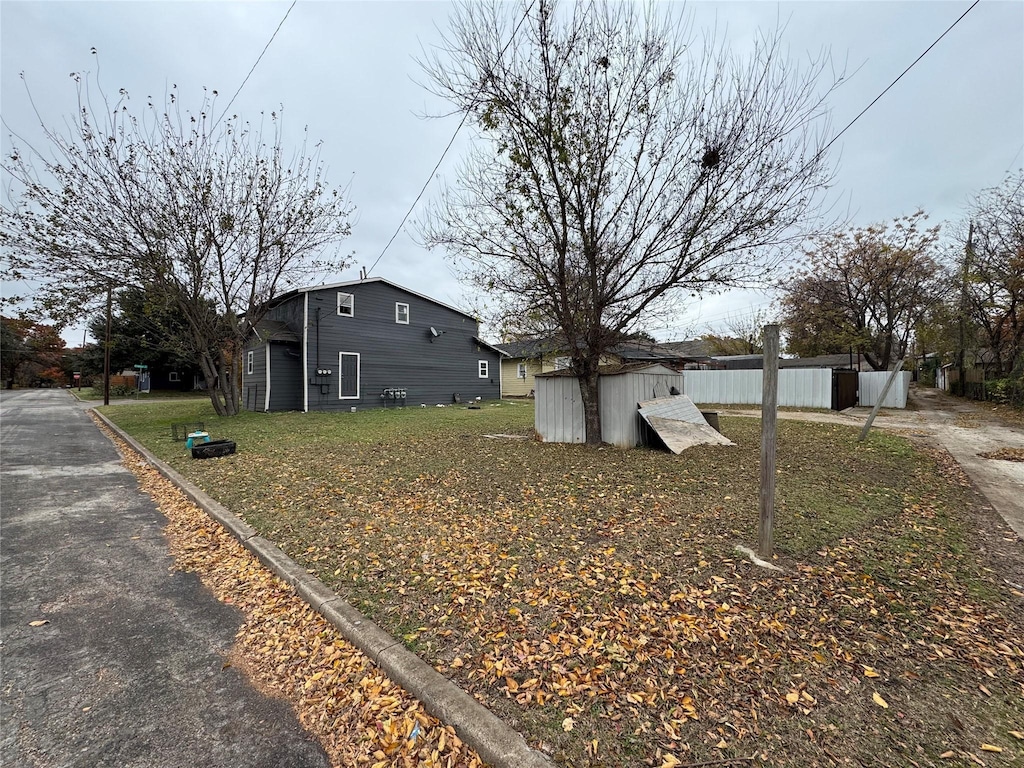 view of side of home featuring a storage shed and an outdoor structure