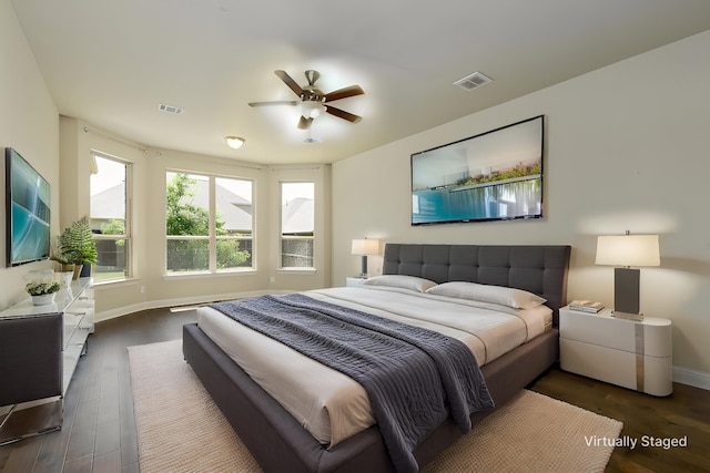 bedroom featuring visible vents, baseboards, and dark wood-style floors