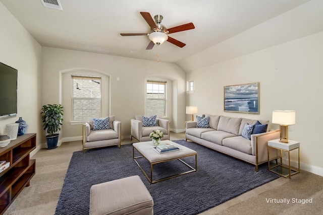 carpeted living room featuring visible vents, baseboards, and ceiling fan