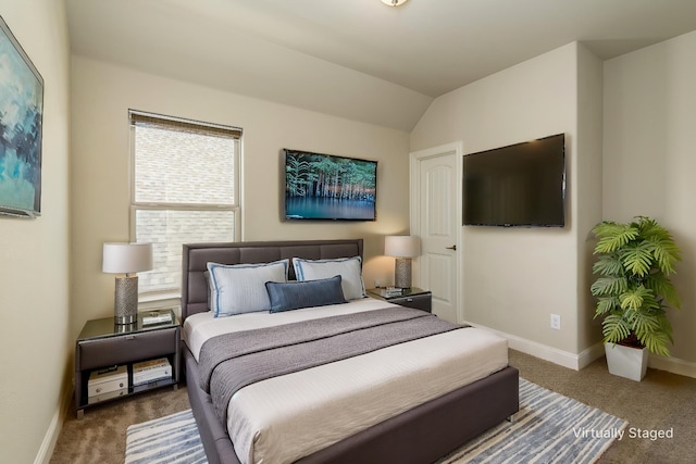 carpeted bedroom with baseboards and vaulted ceiling