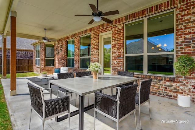 view of patio / terrace with a ceiling fan, outdoor dining area, and fence