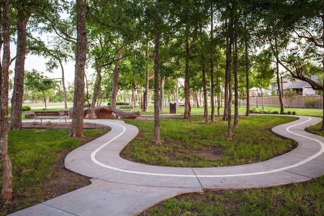 surrounding community with a lawn and fence