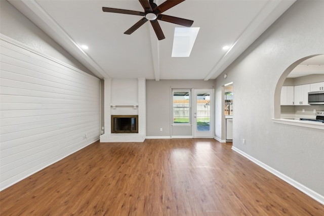 1001 Roaring Springs Dr, Allen, TX 75002 - unfurnished living room with ceiling fan, a brick fireplace, wood finished floors, baseboards, and arched walkways