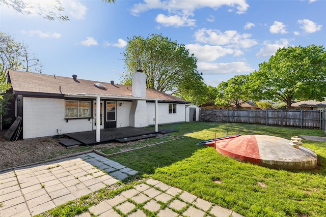 1001 Roaring Springs Dr, Allen, TX 75002 - rear view of house with a patio area, a wooden deck, brick siding, and a chimney