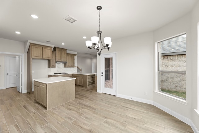 kitchen with visible vents, recessed lighting, a center island, light countertops, and baseboards