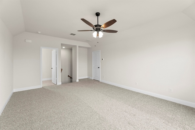 unfurnished room featuring ceiling fan, light colored carpet, baseboards, and lofted ceiling