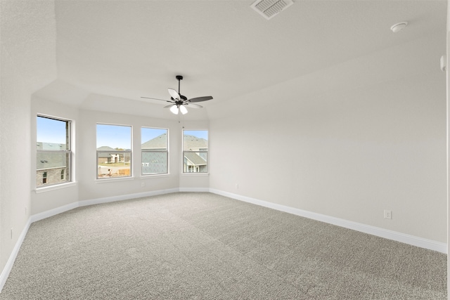 empty room with visible vents, baseboards, a ceiling fan, and light carpet
