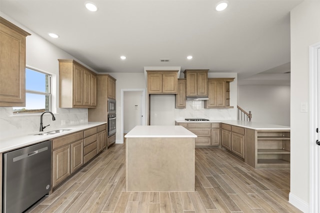 kitchen featuring a center island, dishwasher, cooktop, oven, and built in microwave