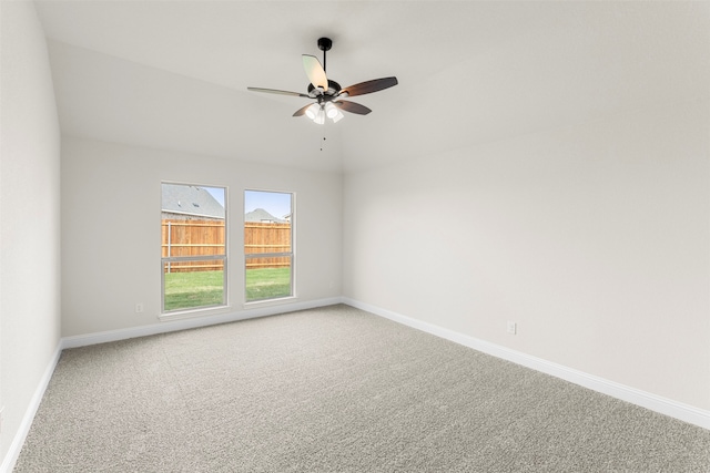 carpeted empty room with baseboards and ceiling fan