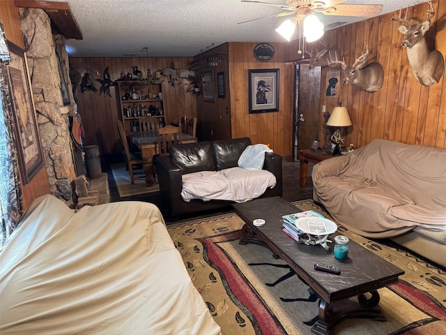 15095 US Highway 82 E, No City, TX 76380 - living area with wood walls, ceiling fan, and a textured ceiling