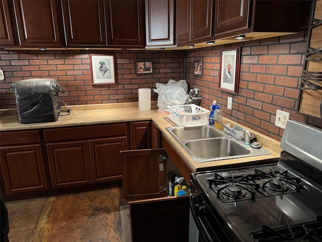 15095 US Highway 82 E, No City, TX 76380 - kitchen with a sink, dark brown cabinets, light countertops, and gas range