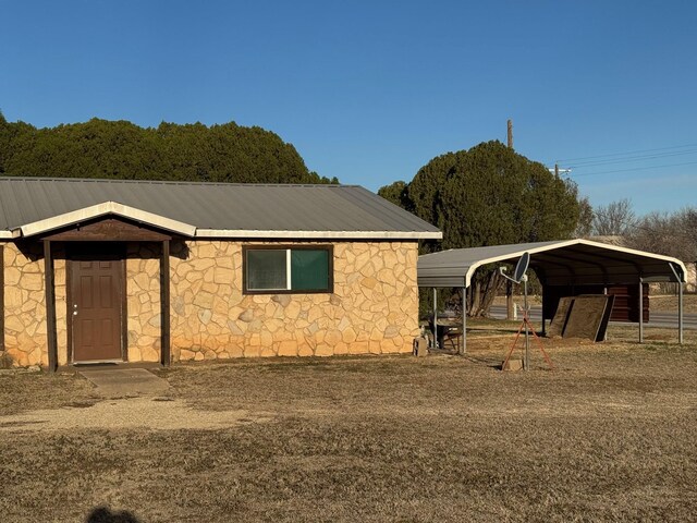 15095 US Highway 82 E, No City, TX 76380 - view of front of property featuring a carport, stone siding, and metal roof