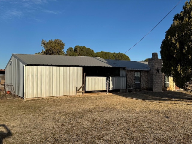 15095 US Highway 82 E, No City, TX 76380 - exterior space with an outdoor structure, metal roof, and a chimney
