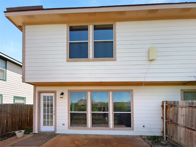 rear view of property with fence
