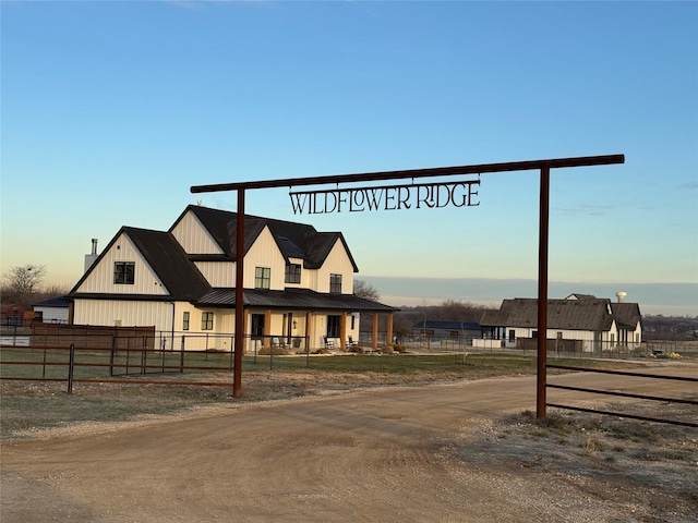 view of front of home featuring board and batten siding and fence