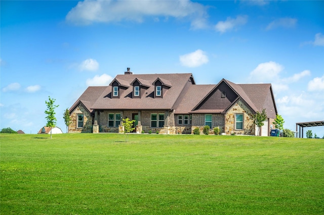 cape cod house with a front lawn, roof with shingles, stone siding, and a chimney
