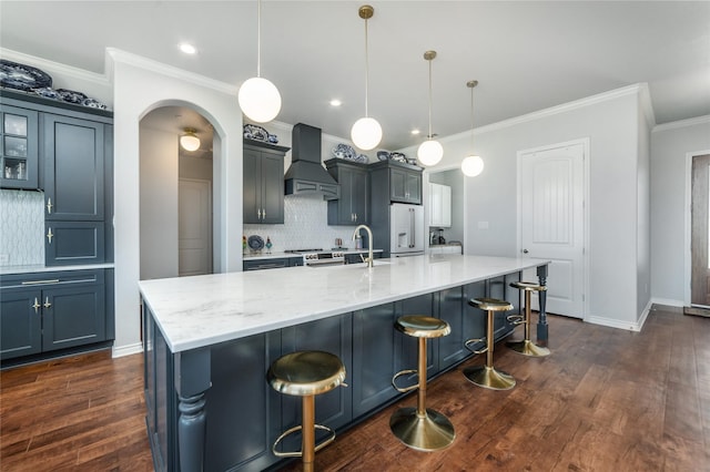 kitchen featuring tasteful backsplash, crown molding, premium range hood, high end fridge, and dark wood-type flooring