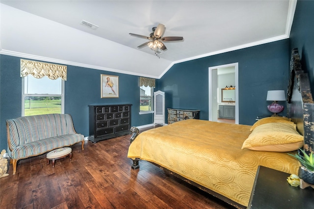bedroom with crown molding, visible vents, vaulted ceiling, and wood finished floors