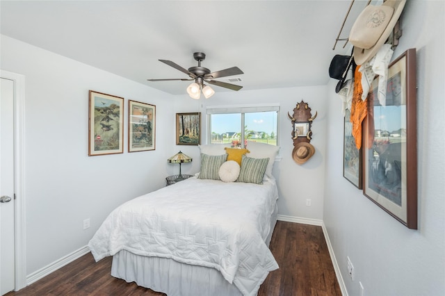 bedroom featuring a ceiling fan, wood finished floors, and baseboards