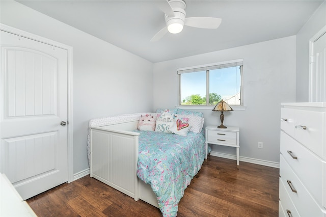 bedroom featuring baseboards, a ceiling fan, and dark wood-style flooring