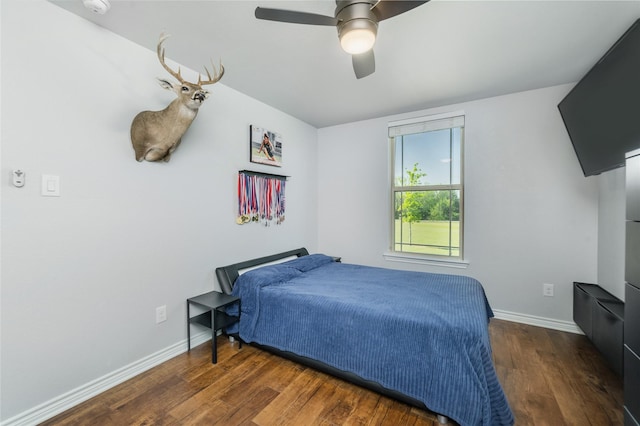 bedroom featuring wood finished floors, ceiling fan, and baseboards
