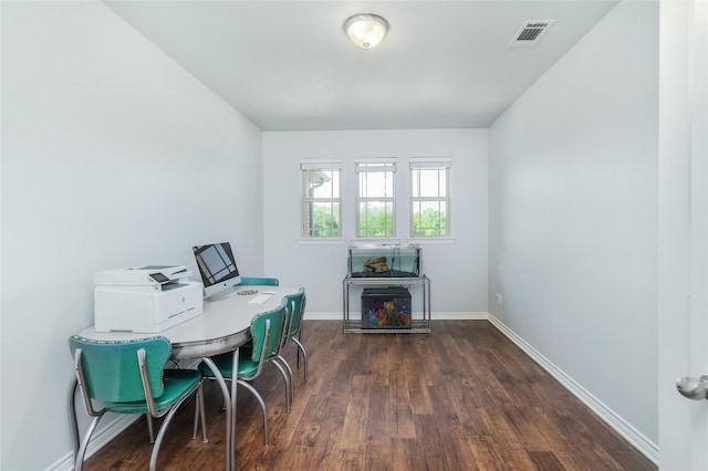 office area featuring dark wood-style floors, visible vents, and baseboards