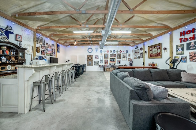 living room featuring concrete flooring and a community bar