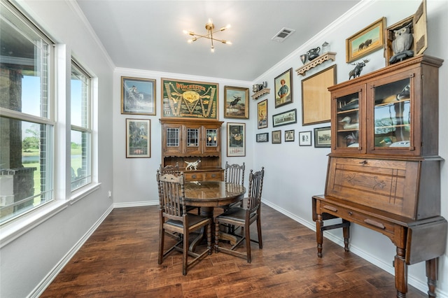 dining space with baseboards, ornamental molding, and dark wood finished floors
