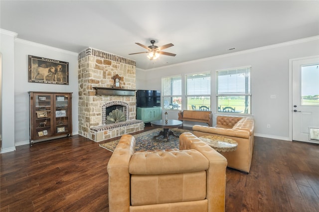 living area featuring hardwood / wood-style flooring, baseboards, ornamental molding, a fireplace, and a ceiling fan