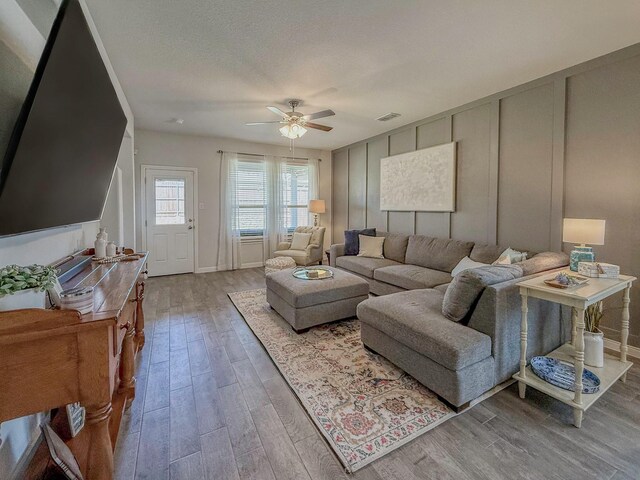 1005 Napier Way, Fort Worth, TX 76247 - living area with a decorative wall, a ceiling fan, and light wood finished floors