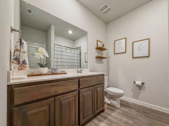 1005 Napier Way, Fort Worth, TX 76247 - bathroom with toilet, wood finished floors, a shower with curtain, and baseboards