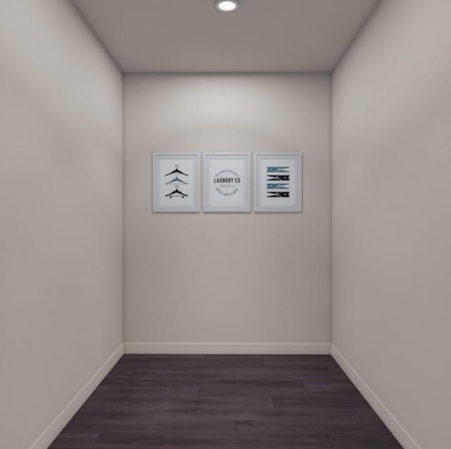 empty room featuring dark wood-type flooring, baseboards, and recessed lighting