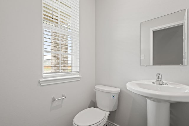 9952 Dynamics Dr, Fort Worth, TX 76131 - bathroom featuring plenty of natural light, toilet, a sink, and baseboards